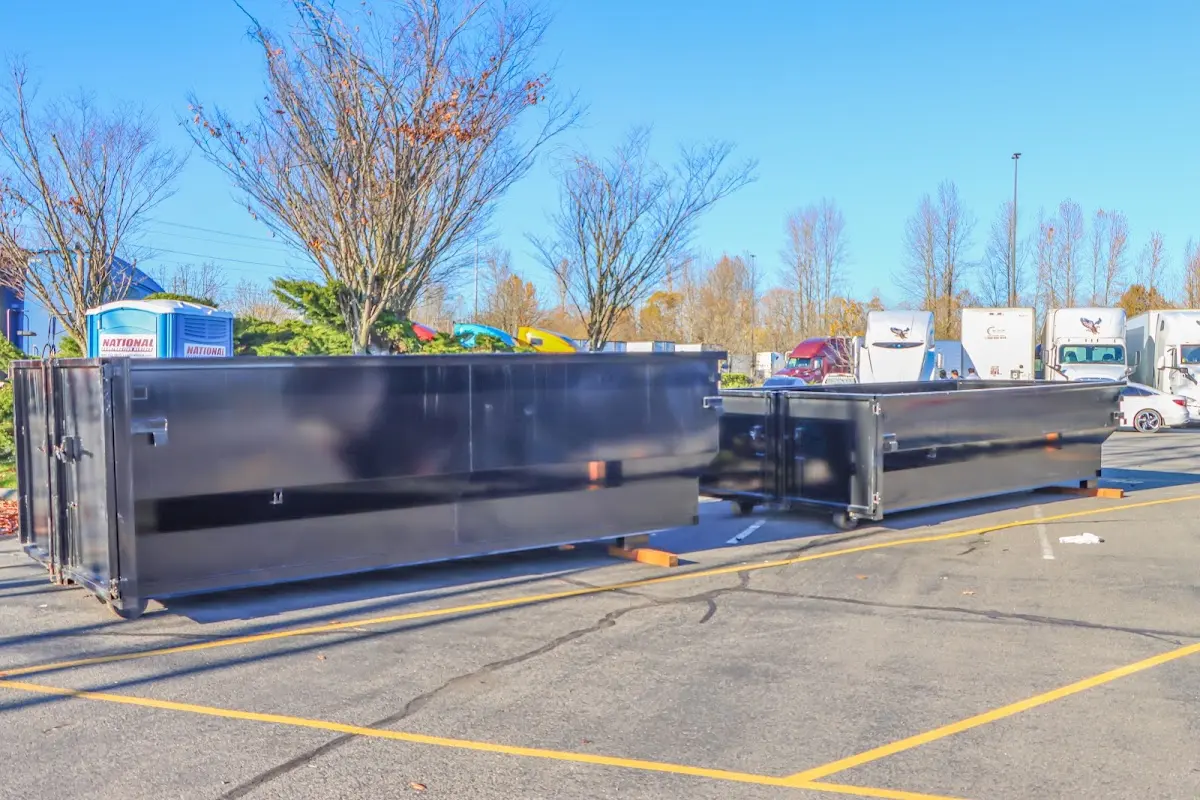 Professional dumpster rental service with roll-off container on residential driveway in Beaverton